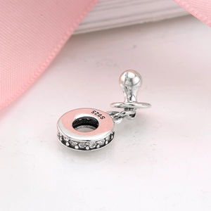 Macro shot of S925 silver pacifier charm with pink enamel and sparkling zircon accents
