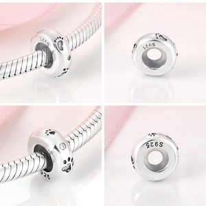 Macro detail of S925 sterling silver paw print charm with zircons for snake chain bracelets