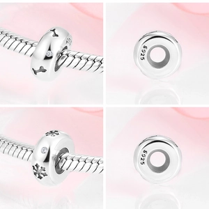 Macro detail of S925 sterling silver charms with bone and snowflake zircon patterns