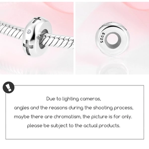 Detailed macro view of S925 sterling silver spacer charm with engraved cross and zircon