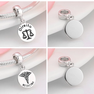Detailed views of S925 sterling silver Law and Medicine charms with engraved symbols