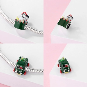 Macro detail of S925 sterling silver Christmas charms with enamel house and festive truck