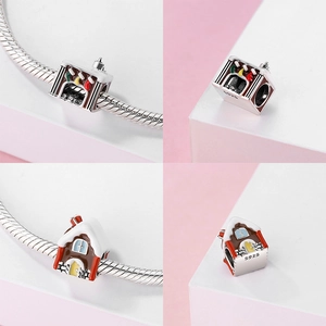 Detailed macro of S925 sterling silver Christmas fireplace and snow cabin charms