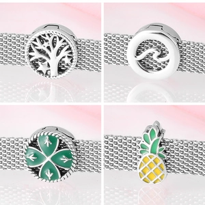 Close-up of S925 silver charms including tree of life and clover on a mesh bracelet