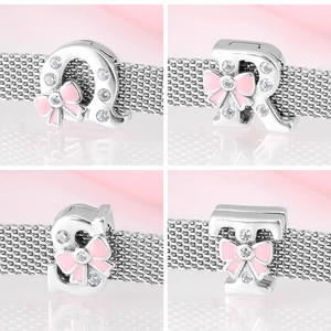 Macro view of 925 silver clip charms featuring letters Q R S T with pink enamel bows