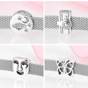 Detailed macro view of S925 sterling silver charms featuring camera and butterfly designs
