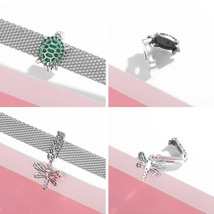 Detail of 925 sterling silver sea turtle and dragonfly charms on mesh bracelet