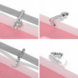 Detailed views of S925 silver heart wing and crescent moon charms with zircon stones