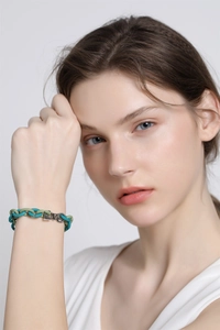 Detail view of the green and grey matte silicone bracelet with a silver LOVE metal clasp