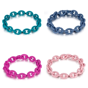 Macro shot of matte silicone chain links in cyan, blue, rose, and light pink shades
