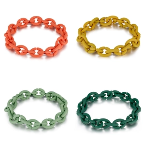Detail view of colorful matte silicone chain bracelets in orange, yellow, green and dark teal
