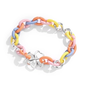 Colorful macaron silicone chain bracelet with silver four-leaf clover charm on white background