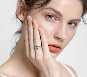Macro shot of silver arrow ring with sparkling cubic zirconia on a female model