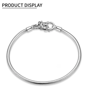 Detail view of S925 sterling silver snake chain bracelet with heart bear clasp