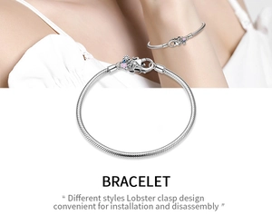 Detail of S925 sterling silver lobster clasp with colorful charms on snake chain