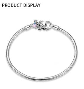 Macro view of S925 sterling silver snake chain bracelet with floral lobster clasp