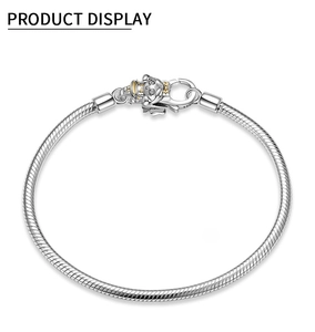 Detail of S925 sterling silver snake chain bracelet with zodiac pig charm and lobster clasp