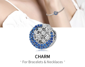 Macro view of sterling silver round charm with blue and white pavé cubic zirconia