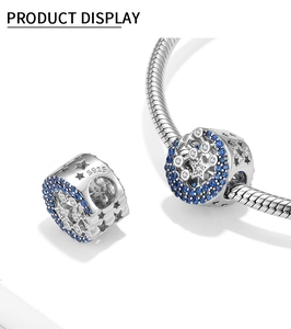 Detailed view of S925 sterling silver moon charm with blue and white cubic zirconia stars