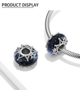 Detailed view of S925 silver celestial star charm with deep blue faceted glass inlay