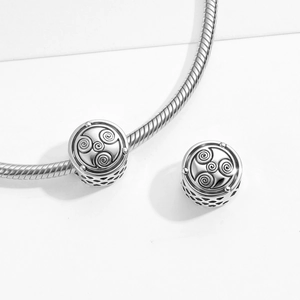 Triskele symbol charm bead in silver finish on snake chain featuring honeycomb hollow design