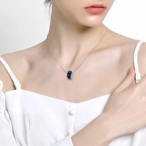 Elegant 925 sterling silver necklace featuring a deep blue oval glass star stone pendant