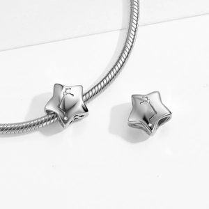 Macro shot of S925 sterling silver star charm with zodiac pattern and zircon accents
