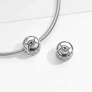 Polished S925 sterling silver evil eye charm with hollow mesh pattern on snake chain