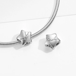 Macro view of S925 sterling silver star charm with zodiac engraving and clear zircon