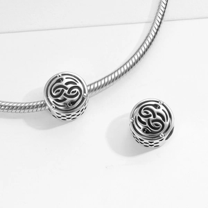 S925 sterling silver snake bone bracelet with double serpent enamel charms on white background