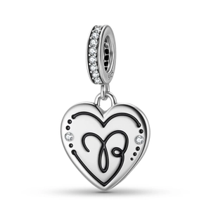 Macro shot of S925 sterling silver heart charm with black enamel and sparkling zircons