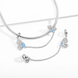 Silver S925 butterfly charm with blue zircon stones and security chain on snake bracelet