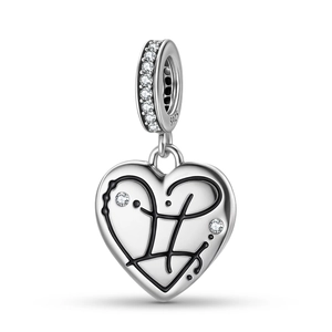 Close-up of S925 sterling silver heart charm with black enamel and sparkling stones