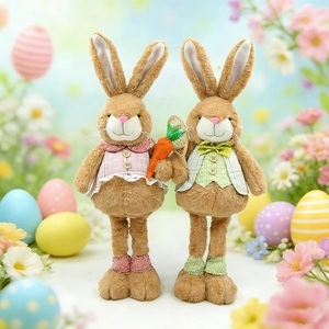 Detail of Easter bunny plush figures with carrot and tennis racket in spring garden