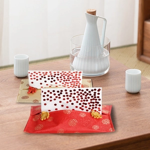 Close-up of fabric tissue cover with traditional patterns and decorative frog button