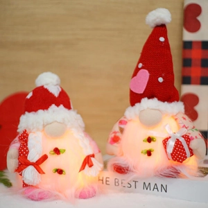 Detail of warm glowing knitted Valentine gnomes with LED lights and heart patterns