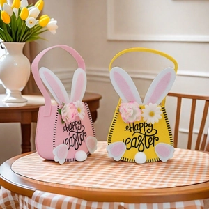 Detail of pink and yellow Easter felt baskets with rabbit ears and fuzzy tails