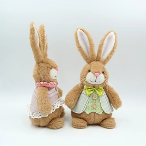 Detail of plush Easter bunnies showing pink lace dress and green plaid vest textures
