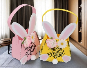 Detailed view of pink and yellow felt Easter bunny baskets with floral accents and plush tails
