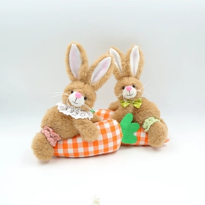 Close-up of Easter plush bunnies with lace collars on an orange plaid carrot base