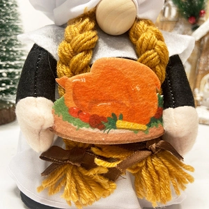 Gnome plush with yellow braids holding a Thanksgiving harvest tray ornament