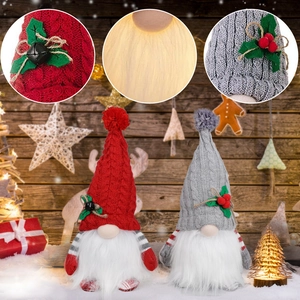 Pair of glowing Christmas gnomes with knit hats and warm LED lights for holiday decor
