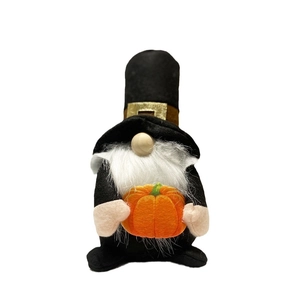 Thanksgiving faceless gnome plush holding an orange pumpkin decorative holiday ornament