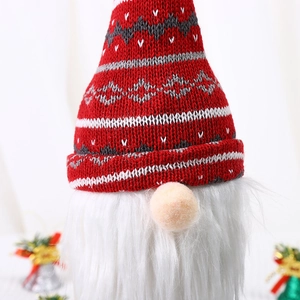 Close-up of a Christmas gnome decoration featuring a red knitted hat and white faux beard