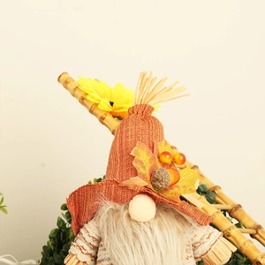 Detailed view of fall harvest gnome with maple leaf decoration and white beard