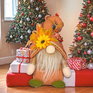 Thanksgiving gnome doll with sunflower and maple leaf on a cozy holiday background