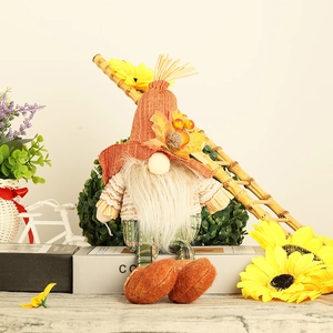 Thanksgiving harvest gnome doll with maple leaf hat and plaid legs on white books