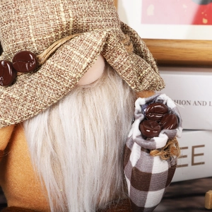 Close-up of coffee gnome plush detail featuring burlap hat with beans and soft white beard