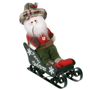 Detail of plush Santa Claus figure on dark green metal sleigh with Merry Christmas text