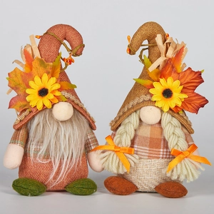 Detail view of Thanksgiving gnome couple with knitted hats and sunflower decorations